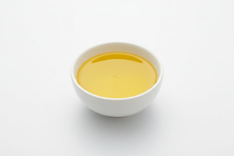 CANOLA OIL IN A WHITE BOWL WITH WHITE BACKROUND
