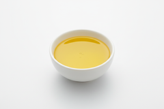 CANOLA OIL IN A WHITE BOWL WITH WHITE BACKROUND